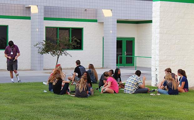 LEAD Green youth gather outside at CCHS to enjoy Pizza Barn pizza on a break between speakers.