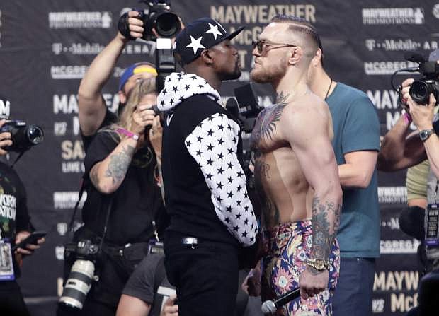 Floyd Mayweather Jr., and Conor McGregor at a news conference at Barclays Center in New York on July 13. throughout the arena. (AP Photo/Frank Franklin II)