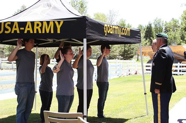 Lt. Col. Michael Gomez presides over an enlistment ceremony for six new recruits at signing celebration for the U.S. Army PaYS partnership with Nevada Builders Alliance.