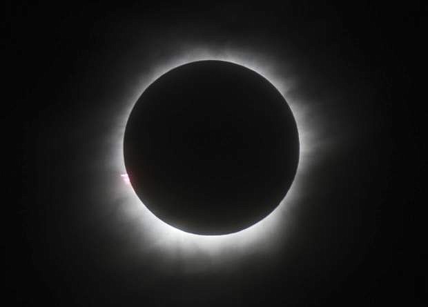 FILE - This March 9, 2016, file photo shows a total solar eclipse in Belitung, Indonesia. A solar eclipse on Monday, Aug. 21, 2017, is set to star in several special broadcasts on TV and online. PBS, ABC, NBC, NASA Television and the Science Channel are among the outlets planning extended coverage of the first solar eclipse visible across the United States in 99 years. (AP Photo/File)