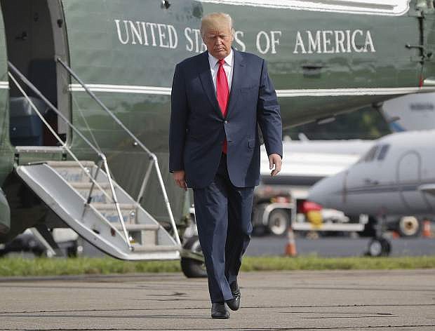 President Donald Trump walks across the tarmac from Marine One to board Air Force One at Morristown Municipal Airport in Morristown, N.J., on Aug. 14.