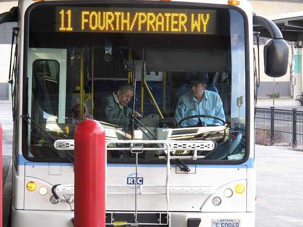 FILE - In this March 2, 2016 file photo, a passenger boards a city bus while the driver looks on at the bus station in downtown Reno, Nev. A federal judge has given northern Nevada&#039;s largest public transit system the green light to begin recording audio along with video surveillance on city buses despite objections from the bus drivers&#039; union that it&#039;s an illegal invasion of privacy. U.S. District Judge Miranda Du said in a ruling this week neither the drivers nor their passengers have a right to privacy because conversations on public buses are not private. (AP Photo/Scott Sonner, File)