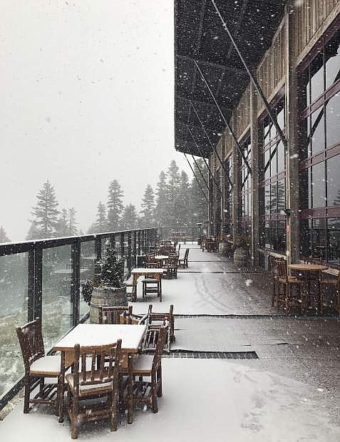In this image provided by Northstar California, flakes of snow come down on Zephyr Lodge at the Northstar California Resort Thursday, Sept. 21, 2017, in Truckee, Calif. Snow is falling in the Sierra Nevada on the last day of summer, dusting hills and ski resorts with fresh snow and stoking excitement for an early skiing season. Forecasters say a rare cool weather system moving south from Oregon is bringing mountain rain and snow showers to the Sierra Thursday. Warmer and drier weather is expected by the weekend. (Northstar California via AP)