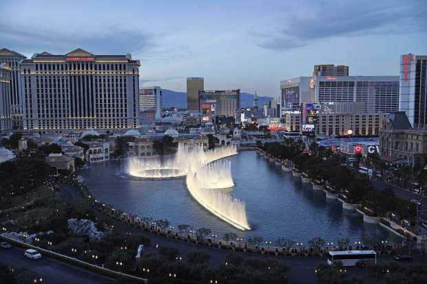 File - In this April 4, 2017, file photo, the fountains of Bellagio erupt along the Las Vegas Strip in Las Vegas. The Nevada Gaming Control Board reported Thursday, July 27, 2017, that casino gambling revenues totaled $895 million in June, up just under 1 percent statewide from the same month last year. (AP Photo/John Locher, File)