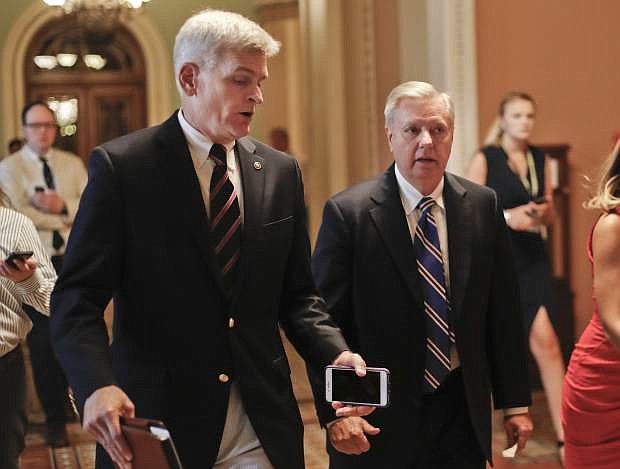 FILE - In this July 13, 2017, file photo, Sen. Bill Cassidy, R-La., left, and Sen. Lindsey Graham, R-S.C., right, talk while walking to a meeting on Capitol Hill in Washington. Senate Republicans are planning a final, uphill push to erase President Barack Obama&#039;s health care law. But Democrats and their allies are going all-out to stop the drive. The initial Republican effort crashed in July in the GOP-run Senate. Majority Leader Mitch McConnell said after that defeat that he&#039;d not revisit the issue without the votes to succeed. Graham and Cassidy are leading the new GOP charge and they&#039;d transform much of Obama&#039;s law into block grants and let states decide how to spend the money. (AP Photo/Pablo Martinez Monsivais, File)