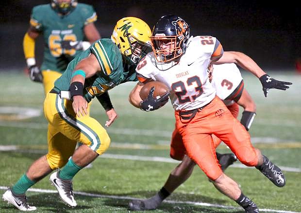 Douglas running back Jack Overton busts one upfield against the Miners Friday night at Bishop Manogue High School.