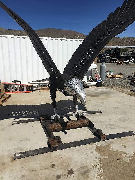 The huge aluminum eagle sculpture sits in the Road and Highway Builders equipment yard awaiting its installation at the south end of the Carson Bypass.