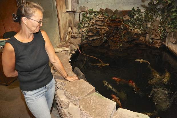 Suzanne Huttman admires one of her mother&#039;s favorite Koi ponds inside the store Thursday.