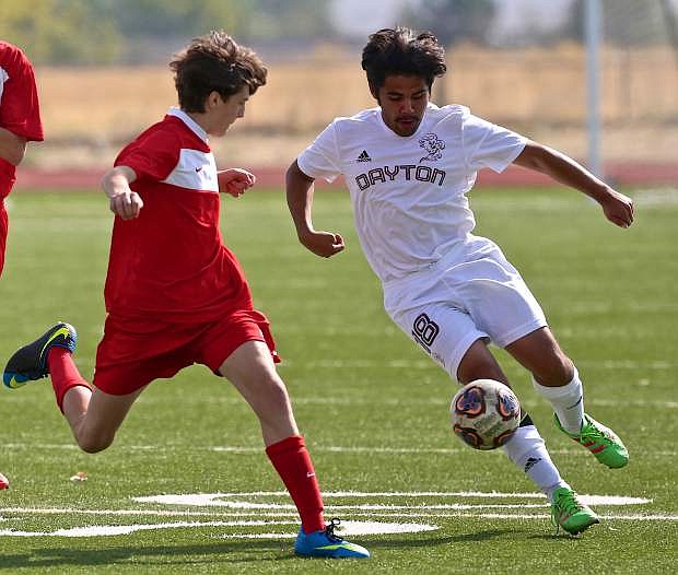 Dayton senior Juan Diaz (18) moves the ball downfield against Whittell on Saturday at DHS.
