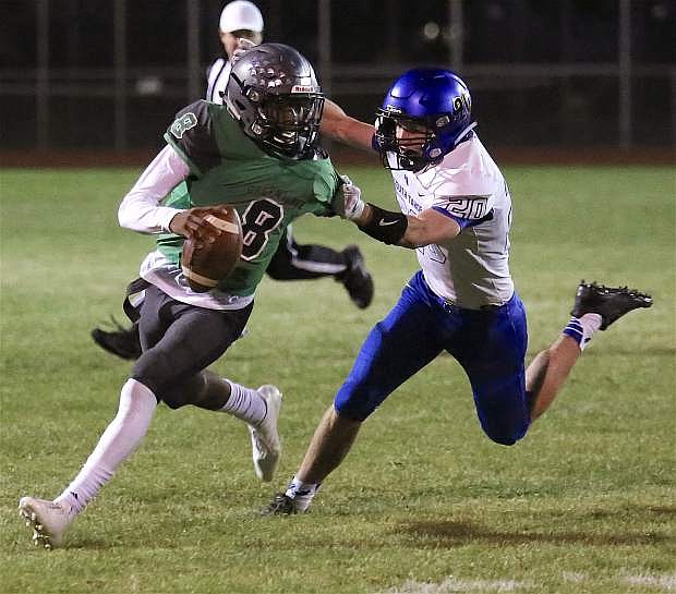 Fallon quarterback Elijah Jackson tries to avoid being taken down by South Tahoe in the Greenwave&#039;s 35-34 win on Friday.