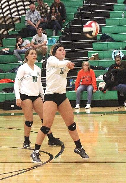 Lorynn Fagg (3) returns the ball to Fernley as Ashley Again stands behind her.