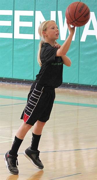 Bailey Skeen shoots for the basket as part of the Churchill County Middle School basketball team.