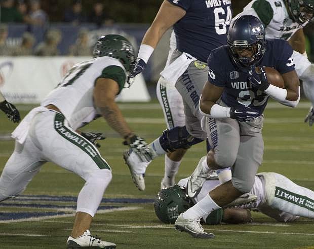 Hawaii linebacker Solomon Matautia (27), left, looks to hit Nevada running back Blake Wright (33) in the first half of an NCAA college football game in Reno, Nev., Saturday, Oct. 7, 2017. (AP Photo/Tom R. Smedes)