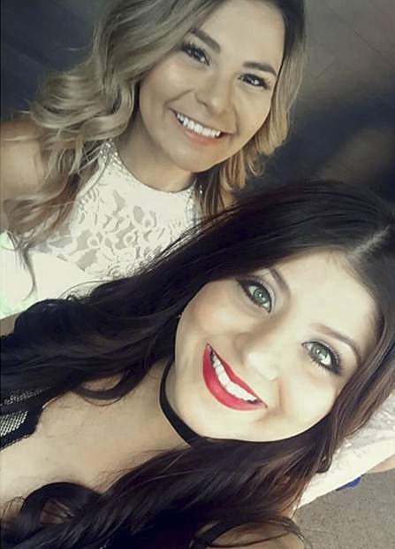 This photo provided by Marissa Nino shows a spring, 2017 self-portrait by her cousin Karessa Royce, 22, lower right, and her friend Pam Rios in Las Vegas. When Royce was wounded in the mass shooting in Las Vegas Sunday, Oct. 1, 2017, Rios rushed her to an ambulance which took her to a hospital. She was shot in the shoulder and is in intensive care following surgery for a collapsed lung, but is expected to survive. (Marissa Nino/Karessa Royce via AP)