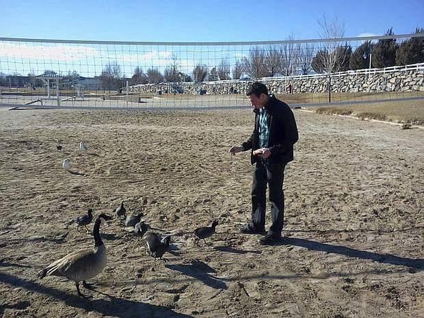 In this 2016 photo provided by the family of John Morse IV, John Morse IV feeds birds months before his death in Reno, Nev. The state of Nevada has agreed to pay $93,000 to settle a wrongful death suit filed by the family of the 27-year-old U.S. Army veteran who was suffering from post-traumatic stress disorder when he hanged himself in prison last year. (AP Photo/Provided by the family of John Morse IV)