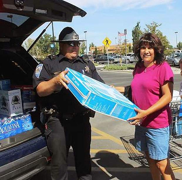 Trooper Trent Barnes receives a fan from a Fallon resident for a Cram the Cruiser event.