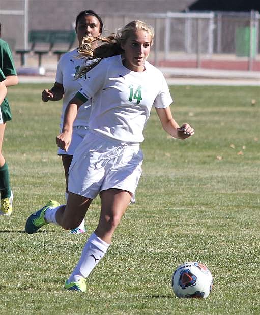 Jordyn Dahl pushes the ball down the field during the Lady Wave&#039;s senior night match against Incline.