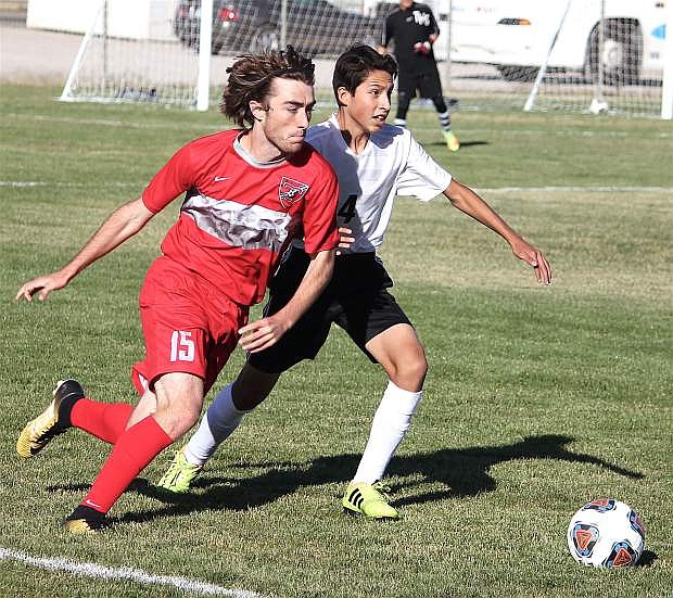 Giovanni Ugalde and Truckee&#039;s Nick Rae fight for possession of the ball.