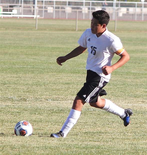 Kevin Duenas kicks the ball back into play during Fallon&#039;s soccer match against Sparks.
