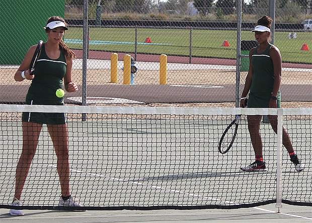 Brynlee Shults and Brooklynn Whitaker prepare for another set during a doubles match against Sparks.