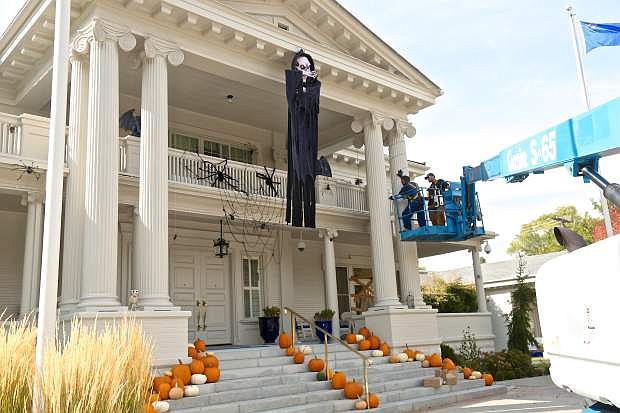 State Buildings and Grounds workers Justin Disney and Phil Nemanic put the finishing touches on Haloween decorations at the Governor&#039;s Mansion Wednesday.