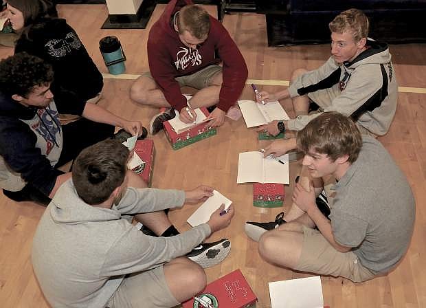 Sierra Lutheran students fill out Christmas cards as part of Operation Christmas Wednesday at the school.