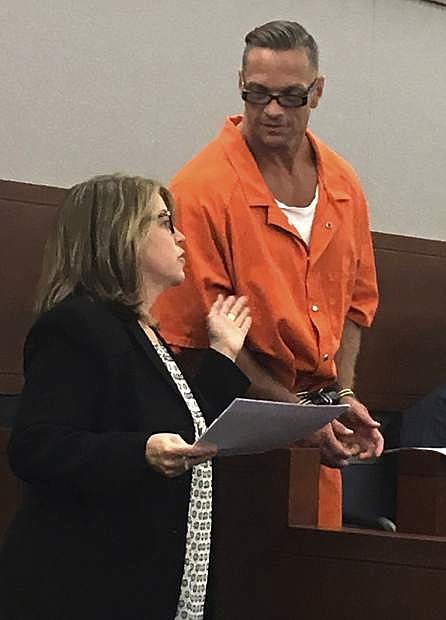 FILE - In this Aug. 17, 2017, file photo, Nevada death row inmate Scott Dozier, right, confers with Lori Teicher, a federal public defender involved in his case, during an appearance in Clark County District Court in Las Vegas. Nevada officials are pressing toward the state&#039;s first execution in 11 years, naming the state&#039;s top psychiatrist as interim replacement for the anesthesiologist who resigned last week after signing off on a lethal injection plan. Jordan Smith, of the state attorney general&#039;s office, told a judge Monday, Nov. 6, 2017, in Las Vegas that Dr. Leon Ravin has replaced Dr. John DiMuro as the state&#039;s top doctor. That makes Ravin the medical official with primary responsibility for next week&#039;s scheduled execution of twice-convicted murderer Dozier. (AP Photo/Ken Ritter, File)