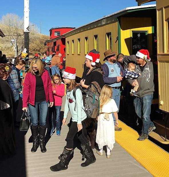 Parents and children depart the rail passenger cars during the 2016 Santa Train at the Nevada State Railroad Museum in Carson City.