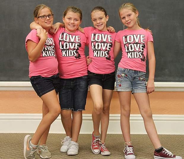 The Love Love Kids, left to right, Amanda, Sofia, Brittany and Paris take a break during a music video film shoot at the Dayton Community Center.