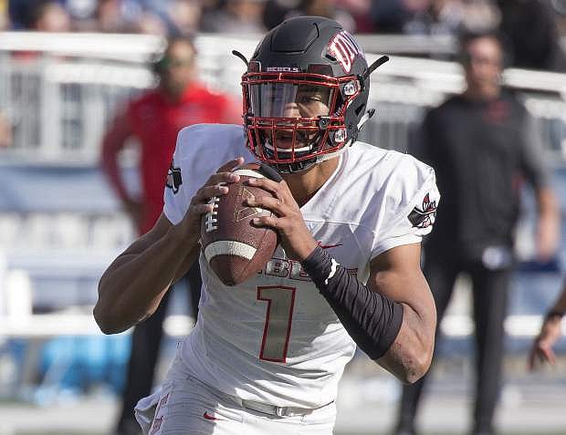 UNLV quarterback Armani Rogers looks to throw against Nevada in the first half of an NCAA college football game in Reno, Nev., Saturday, Nov. 25, 2017. (AP Photo/Tom R. Smedes)
