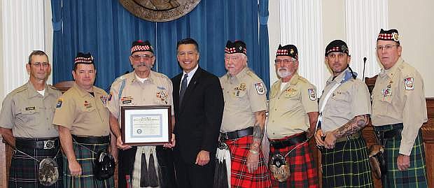 Gov. Brian Sandoval posed with the Scottish American Military Society Honor Guard post 1864 after they were recognized as Veteran Supporter of the Month.
