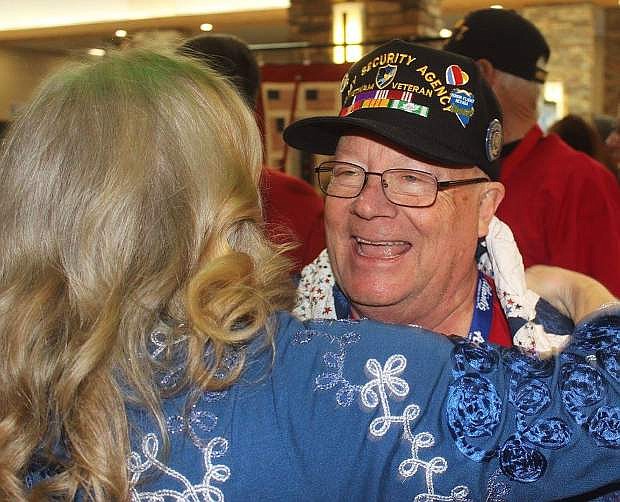 Bob Martin receives a hug after receiving a quilt made especially for Honor Nevada Flight veterans.