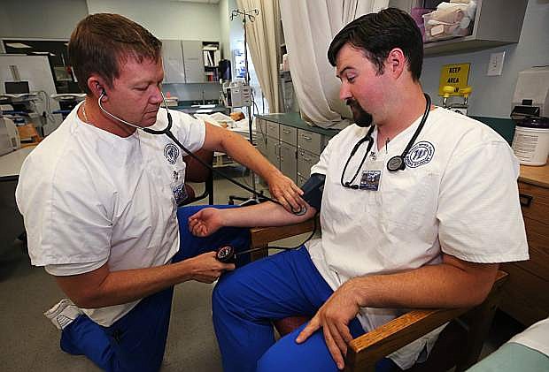 Joseph Yearn and Quentin Knowles work in a nursing class at Western Nevada College in Carson City, Nev., on Tuesday, Sept. 19, 2017.