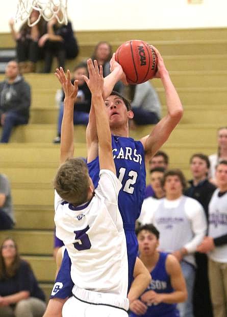 Carson&#039;s Trent Robison shoots a jumper over a Spanish Springs defender on Tuesday night.