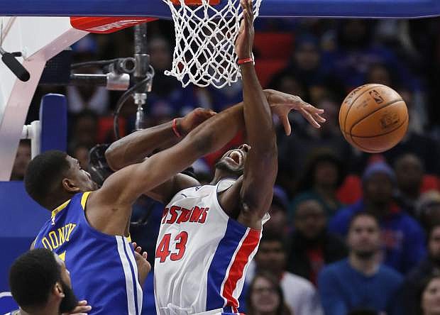 Golden State forward Kevon Looney (5) blocks a shot by Detroit forward Anthony Tolliver during the second quarter Friday.