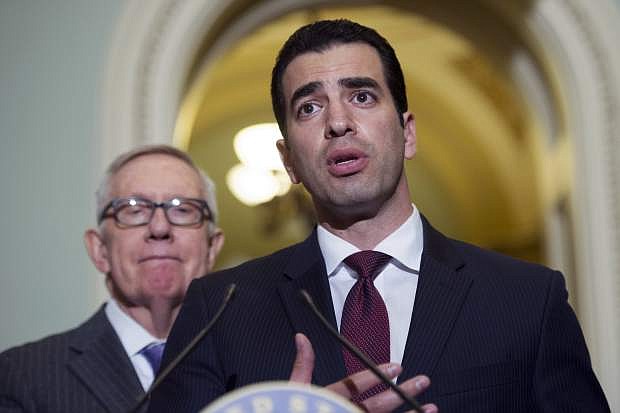 FILE - This Nov. 14, 2016 file photo Rep.-elect Ruben Kihuen, D-Nev.,right, speaks with reporters as Sen. Harry Reid, D-Nev., left, listens on Capitol Hill in Washington. The chairman of the House Democrats&#039; campaign committee called on Kihuen to step down after a report Friday, Dec. 1, 2017, that he allegedly sexually harassed his campaign&#039;s finance director. (AP Photo/Cliff Owen,File)