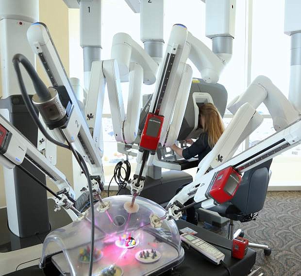 On display Tuesday at the Carson Tahoe Regional Medical Center, Dr. Kira Brooks demostrates the use of the Da Vinci Xi, which is the latest generation of robotic surgery technology.