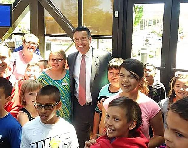 Nevada Gov. Brian Sandoval poses for a photo with 4th-grade students from Mark Twain Elementary School in Carson City in the Dema Guinn Concourse of the Nevada State Museum in this May 26, 2017 photo. The 2017 Nevada Legislature approved $500,000 in funding to reimburse school disctricts for the cost of transporting students on field trips to the seven state museums. Peter Barton/Nevada Division of Museums and History