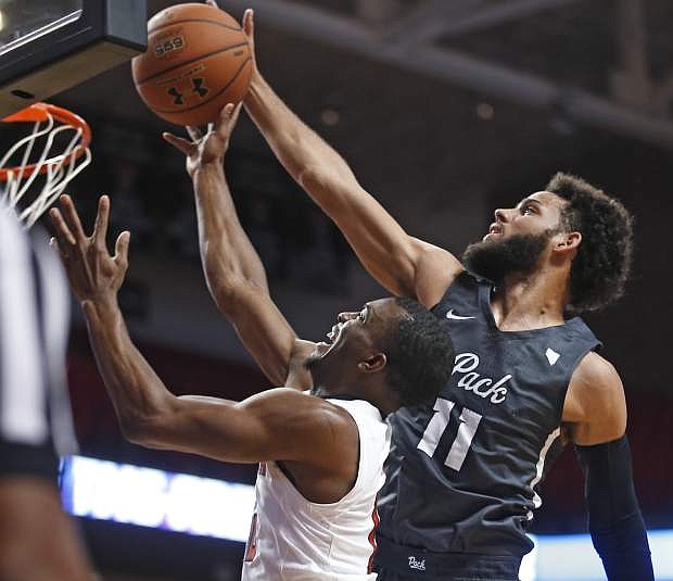 Nevada&#039;s Cody Martin (10) fouls Texas Tech&#039;s Keenan Evans (12) on a shot during the first half an NCAA college basketball game Tuesday, Dec. 5, 2017, in Lubbock, Texas. (AP Photo/Brad Tollefson)