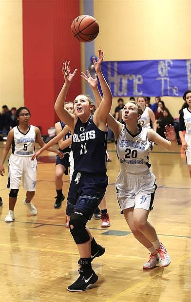Oasis Academy&#039;s Taryn Berrenchea, 11, tries to snag the rebound before Coral Academy&#039;s Zoe Maletsky.