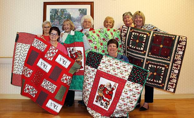 Members of Capital Quilters gather on Nov. 29 to present Carson Tahoe Health with 87 quilts for babies born this holiday season.