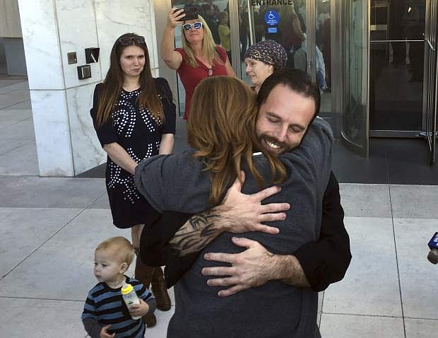 Nevada ranching standoff defendant Ryan Payne, facing camera, hugs a friend outside the U.S. District Courthouse in Las Vegas following his release on Friday after 22 months in federal custody.