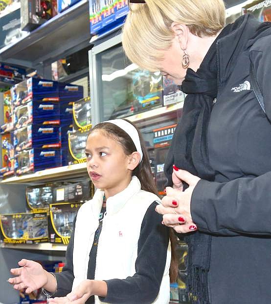 9-year-old Ka&#039;Lea explains what kind of gift she would like to purchase for her brother to the Rotary Club&#039;s Susie Messina Saturday at Walmart.