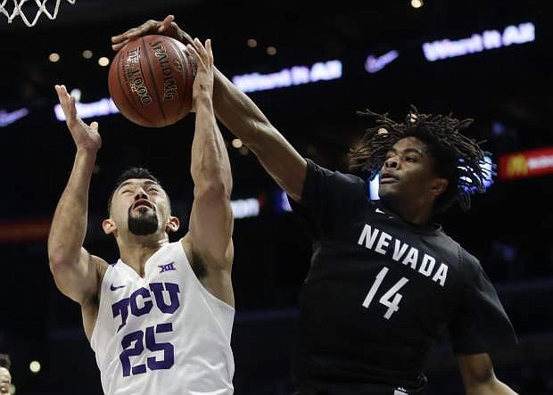 Nevada guard Lindsey Drew, right, blocks a shot by TCU guard Alex Robinson during the first half in Los Angeles on Dec. 8.