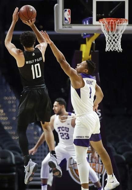 Nevada forward Caleb Martin, left, shoots over TCU guard Desmond Bane in a game earlier this season. Tuesday night, Martin came off the bench to score 22 points in a win against UC Davis in Reno.