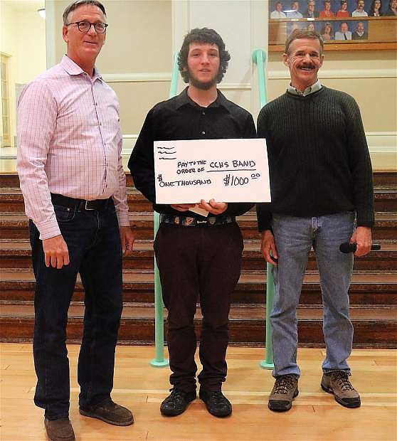 From left, Churchill County High School Music Instructor Tom Fleming with CCHS senior Shawn Bolt, accepting a check from School Board Trustee Richard Gent at the Jan. 10 meeting.
