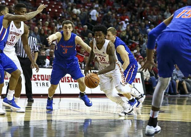 UNLV guard Jovan Mooring (30) drives through Boise State&#039;s defense during Saturday&#039;s game. Boise State won, 83-74.