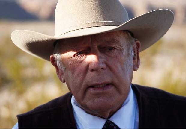In a Wednesday, Jan. 27, 2016 file photo, rancher Cliven Bundy speaks to media while standing along the road near his ranch, in Bunkerville, Nev.
