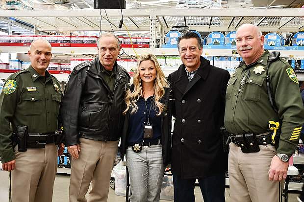 Carson City Sheriff&#039;s Capt. Brian Humphrey, Sheriff Ken Furlong, Chief of Juvenile Services Ali Banister, Gov. Brian Sandoval and Capt. Jeff Melvin participate in the 14th annual Holiday with a Hero Wednesday.