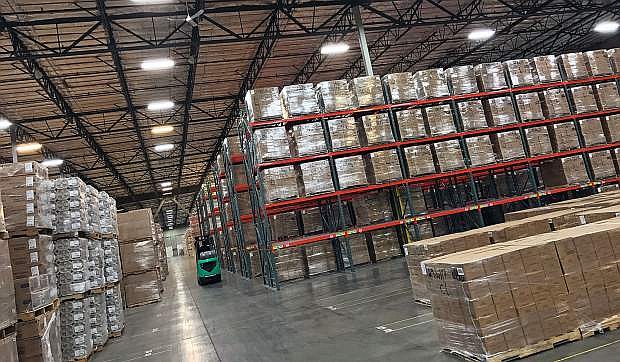 A forklift maneuvers through the ITS warehouse on Vista Boulevard.